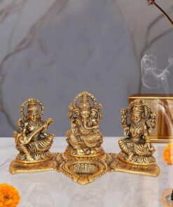 Amazon Brand - Umi Metal Ganesha Lakshmi and Saraswati Idol Metal Sculpture Seated On Peacock Throne Golden Height 4.0 Inches Width 7.5 Inches Medium